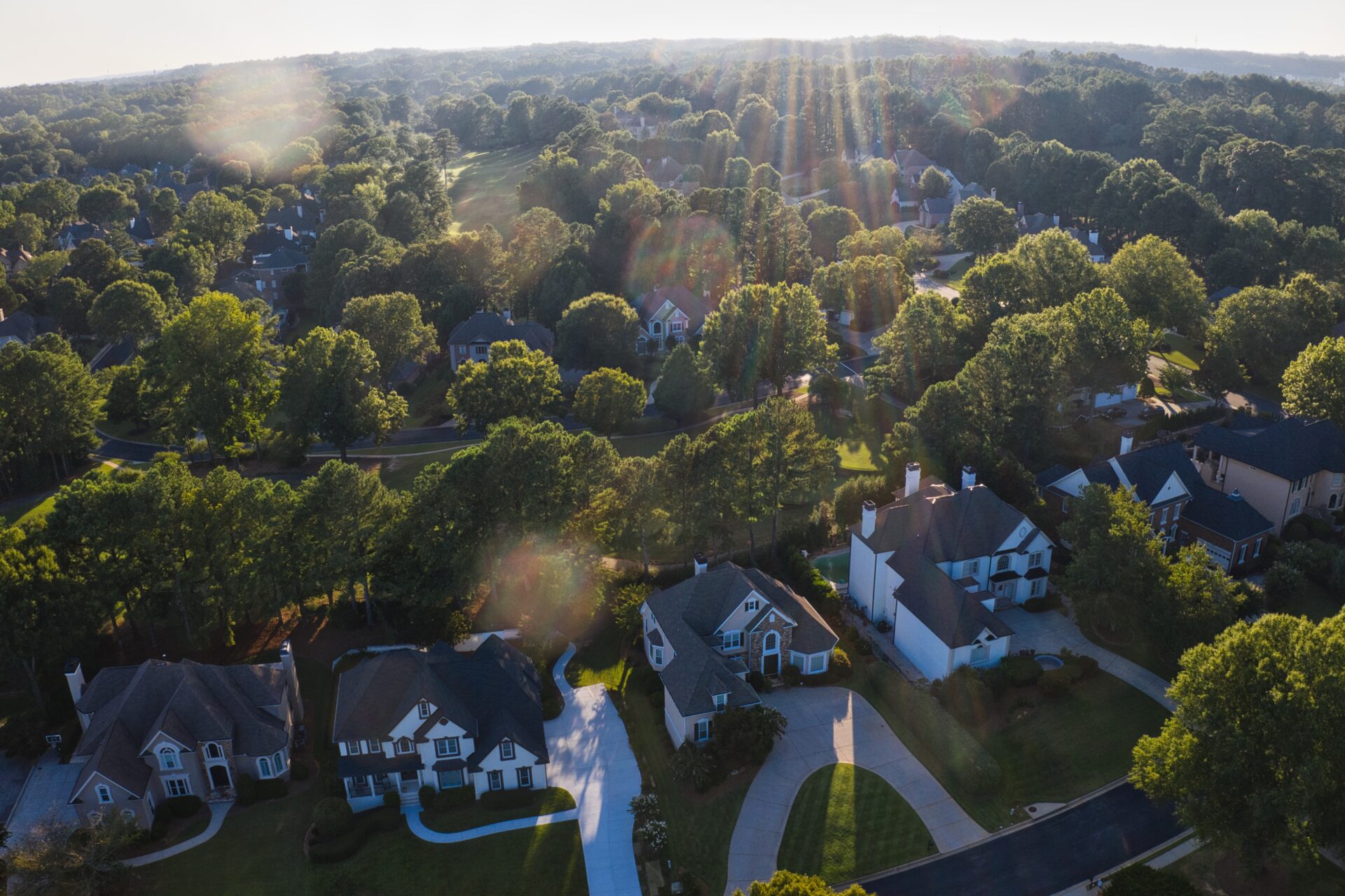 Aerial panoramic view of an upscale subdivision in suburbs of USA shot during sunset